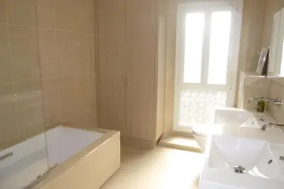 a bathroom with a tub and a toilet and a sink at REF 990 - Cannes Center - Apartment for rent in Cannes