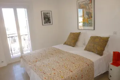 a bedroom with a bed and a window at REF 990 - Cannes Center - Apartment for rent in Cannes