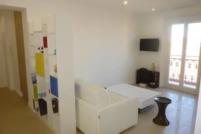 a living room with a white couch and a table at REF 990 - Cannes Center - Apartment for rent in Cannes