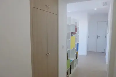 a room with wooden cabinets and a hallway at REF 990 - Cannes Center - Apartment for rent in Cannes