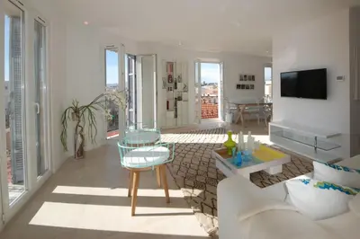 a living room with a couch and a table at REF 945 - Cannes Center - Apartment for rent in Cannes