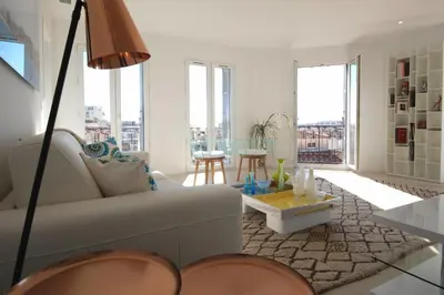 a living room with a couch and a table at REF 945 - Cannes Center - Apartment for rent in Cannes