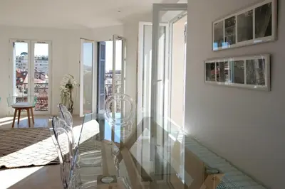 a glass table and chairs in a room with a view at REF 945 - Cannes Center - Apartment for rent in Cannes