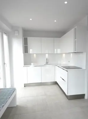 a white kitchen with white cabinets and a sink at REF 945 - Cannes Center - Apartment for rent in Cannes