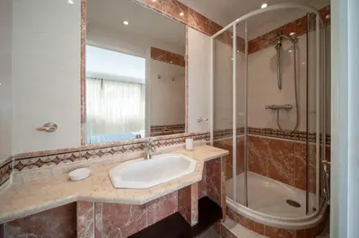 a bathroom with a sink and a shower at REF 30 - Cannes Croisette - Sea and gardens view apartment for rent in Cannes