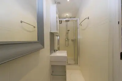 a bathroom with a shower and a sink and a mirror at Forville Coeur de Cannes in Cannes