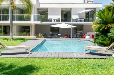 a swimming pool in front of a house at REF 1941 - Cannes Center - Villa for rent in Cannes