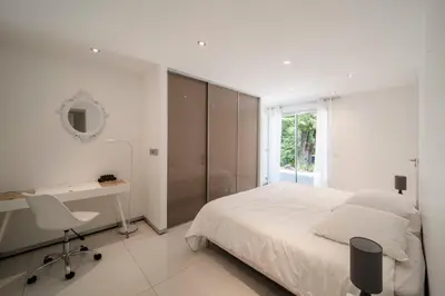 a bedroom with a bed and a desk and a mirror at REF 1941 - Cannes Center - Villa for rent in Cannes