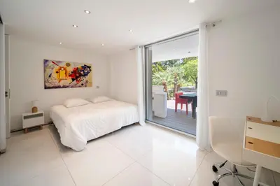 a bedroom with a bed and a sliding glass door at REF 1941 - Cannes Center - Villa for rent in Cannes
