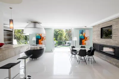 a kitchen with a table and chairs and a fireplace at REF 1941 - Cannes Center - Villa for rent in Cannes