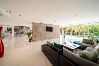 a living room with a couch and a tv at REF 1941 - Cannes Center - Villa for rent in Cannes