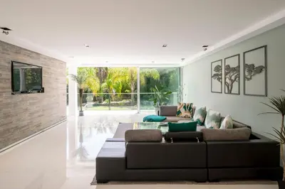 a living room with a couch and a tv at REF 1941 - Cannes Center - Villa for rent in Cannes