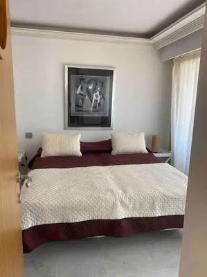 a bedroom with a large bed with two pillows at Lumineux top terrasse 2P in Cannes