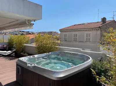 a hot tub sitting on top of a patio at Lumineux top terrasse 2P in Cannes