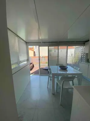a dining room with a table and chairs in a house at Lumineux top terrasse 2P in Cannes