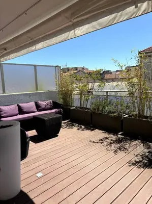 a patio with purple cushions and a bench on a balcony at Lumineux top terrasse 2P in Cannes