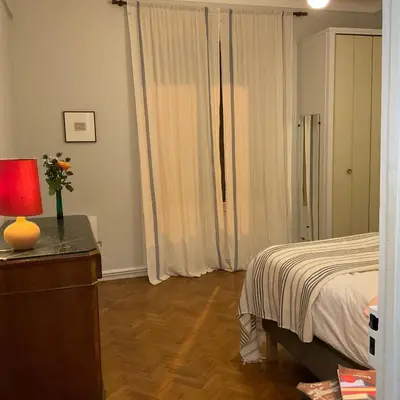 a bedroom with a bed and a table with a lamp at Palais Gothique in Cannes