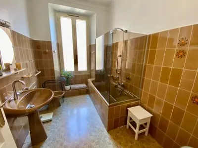 a bathroom with a sink and a tub and a shower at Palais Gothique in Cannes