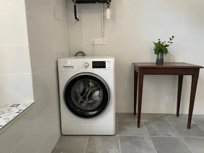 a washing machine in a room with a table at Palais Gothique in Cannes