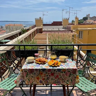 a table with food on top of a balcony at Palais Gothique in Cannes