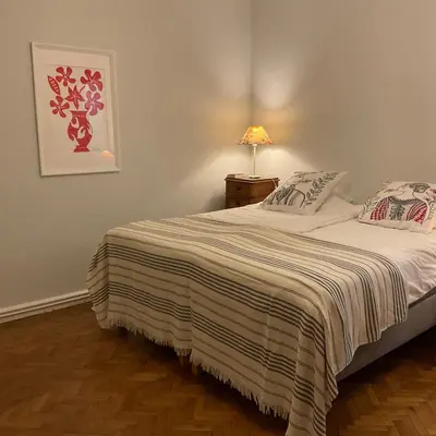a bedroom with a bed with a striped blanket at Palais Gothique in Cannes