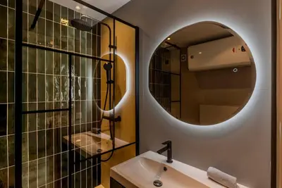 a bathroom with a sink and a mirror at Le Grand Hôtel -Centre Croisette in Cannes