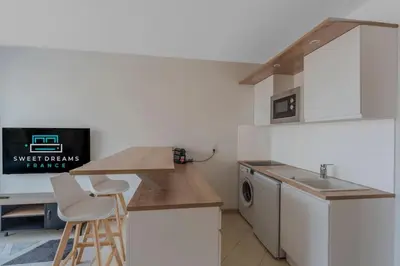 a kitchen with a counter and a sink and a stove at Le Grand Hôtel -Centre Croisette in Cannes