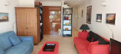 a living room with a red couch and a blue chair at Le Panoramique - Cannes - City Centre - Sea View - Swimming pool - Free Parking in Cannes
