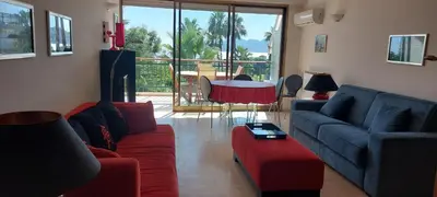 a living room with a couch and a table at Le Panoramique - Cannes - City Centre - Sea View - Swimming pool - Free Parking in Cannes