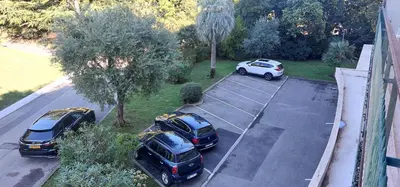 an overhead view of three cars parked in a parking lot at Le Panoramique - Cannes - City Centre - Sea View - Swimming pool - Free Parking in Cannes