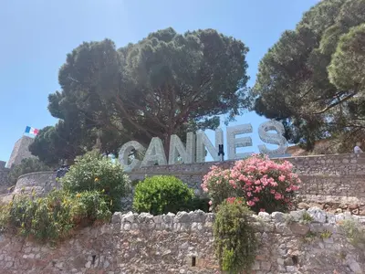 a sign that says cannes behind a stone wall at Le Panoramique - Cannes - City Centre - Sea View - Swimming pool - Free Parking in Cannes
