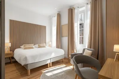 a bedroom with a bed and a desk and a chair at Cannes heart, 3 BR, 3 Bath, 100m Palais & beach in Cannes