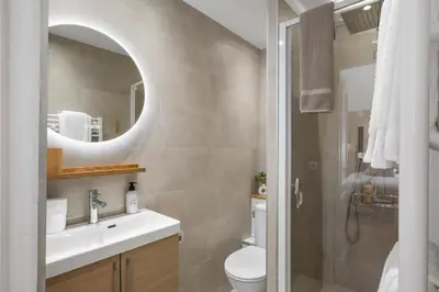 a bathroom with a sink and a toilet and a mirror at Cannes heart, 3 BR, 3 Bath, 100m Palais & beach in Cannes