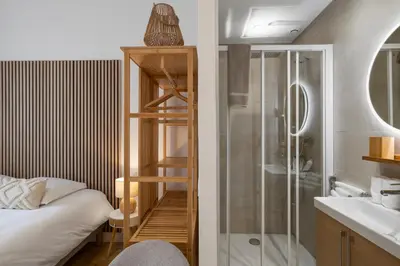 a bathroom with a shower and a bed and a sink at Cannes heart, 3 BR, 3 Bath, 100m Palais & beach in Cannes