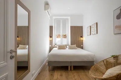 a bedroom with two beds and a mirror at Cannes heart, 3 BR, 3 Bath, 100m Palais & beach in Cannes