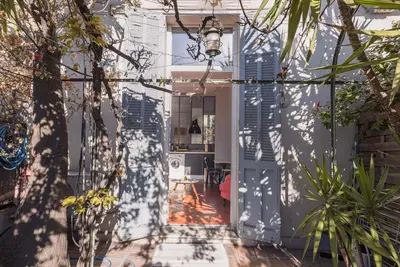 a hallway of a house with a door and trees at L'Atelier - Jardin, 8mn Palais&Plage, spacieux in Cannes