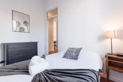 a bedroom with two beds and a dresser at L'Atelier - Jardin, 8mn Palais&Plage, spacieux in Cannes