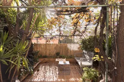 a pergola with a bench in a garden at L'Atelier - Jardin, 8mn Palais&Plage, spacieux in Cannes