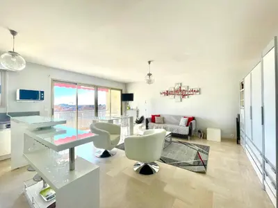 a living room with a glass table and chairs at Petit Juas by Welcome to Cannes in Cannes