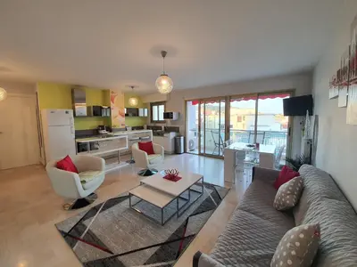 a living room with a couch and a table at Petit Juas by Welcome to Cannes in Cannes