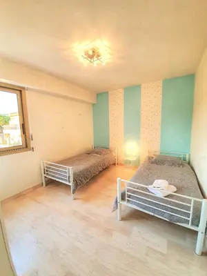 a room with two beds and a window at Petit Juas by Welcome to Cannes in Cannes