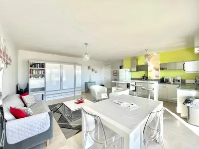 a kitchen and living room with a table and chairs at Petit Juas by Welcome to Cannes in Cannes