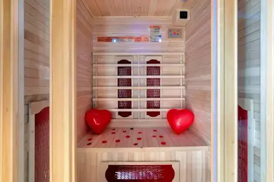 two red hearts are sitting in a sauna at The Jungle - Jacuzzi, Sauna & Projector in Cannes