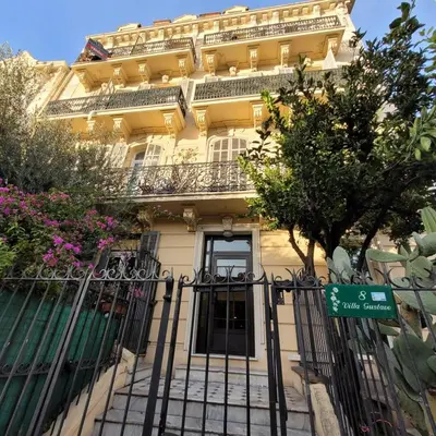 a building with a gate in front of it at Villa Gustave, studio confort avec balcon Centre Cannes in Cannes