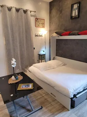 a bedroom with a double bed and a side table at Villa Gustave, studio confort avec balcon Centre Cannes in Cannes