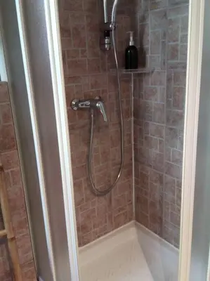 a shower with a hose in a bathroom at Villa Gustave, studio confort avec balcon Centre Cannes in Cannes