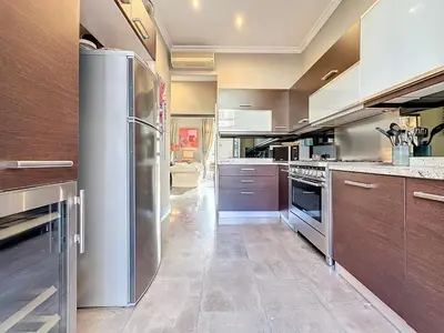 a large kitchen with a stainless steel refrigerator at Beautiful 2 bedroom bourgeois style Antibes 333 in Cannes