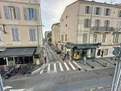 a city street with buildings and people walking on the street at Beautiful 2 bedroom bourgeois style Antibes 333 in Cannes