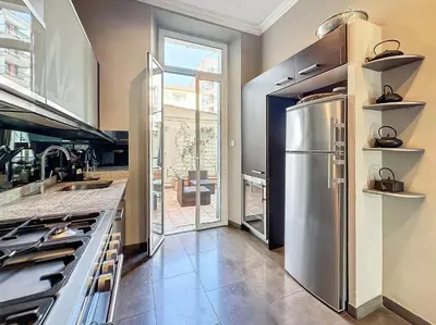 a kitchen with a stainless steel refrigerator at Beautiful 2 bedroom bourgeois style Antibes 333 in Cannes