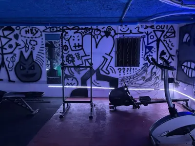 a gym with a wall covered in graffiti at L'Écrin d'Azur – Villa, Cinéma & Plage à 50m in Cannes